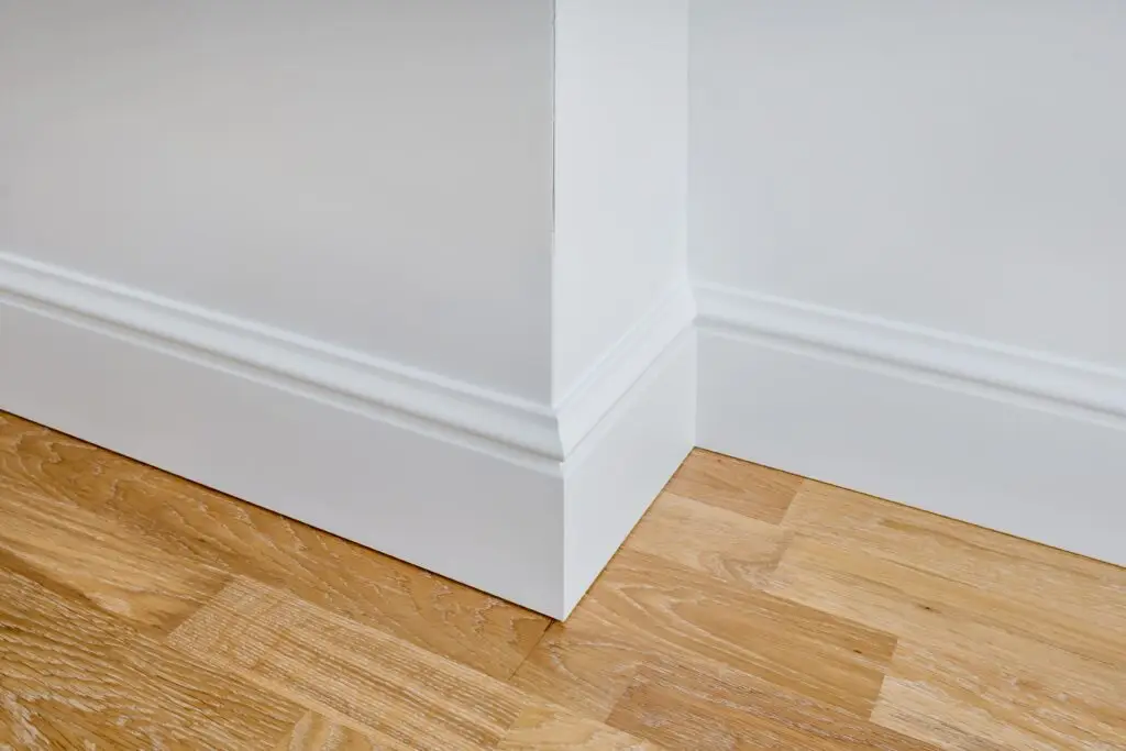 Caulk baseboards to vinyl flooring